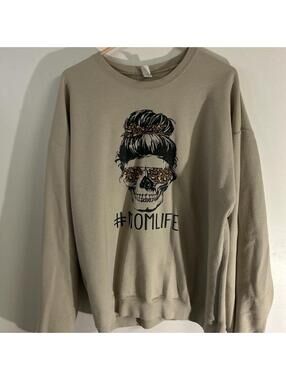 Tan crewneck sweater with a fun graphic #momlife